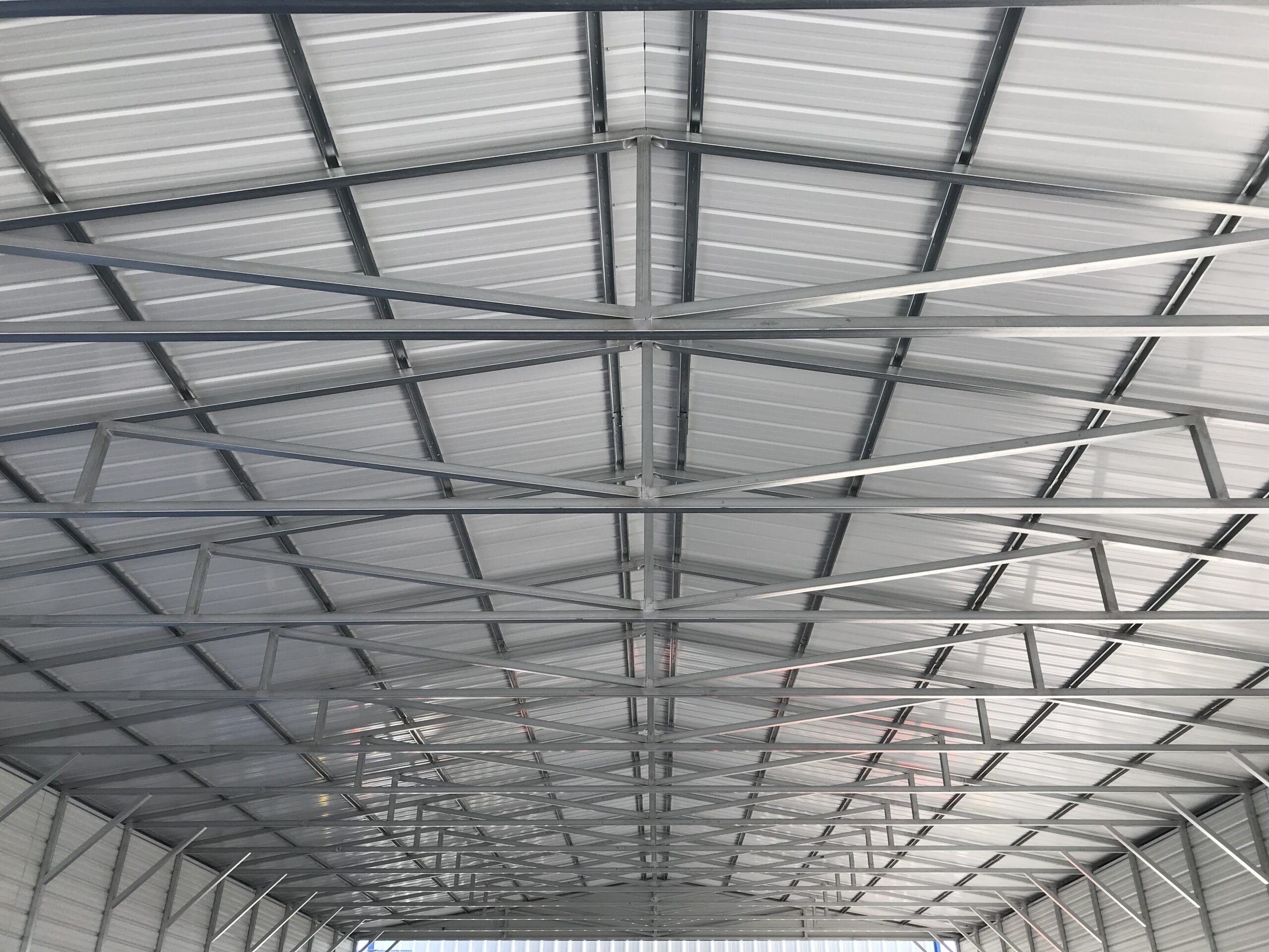 A metal ceiling with multiple rows of white panels.