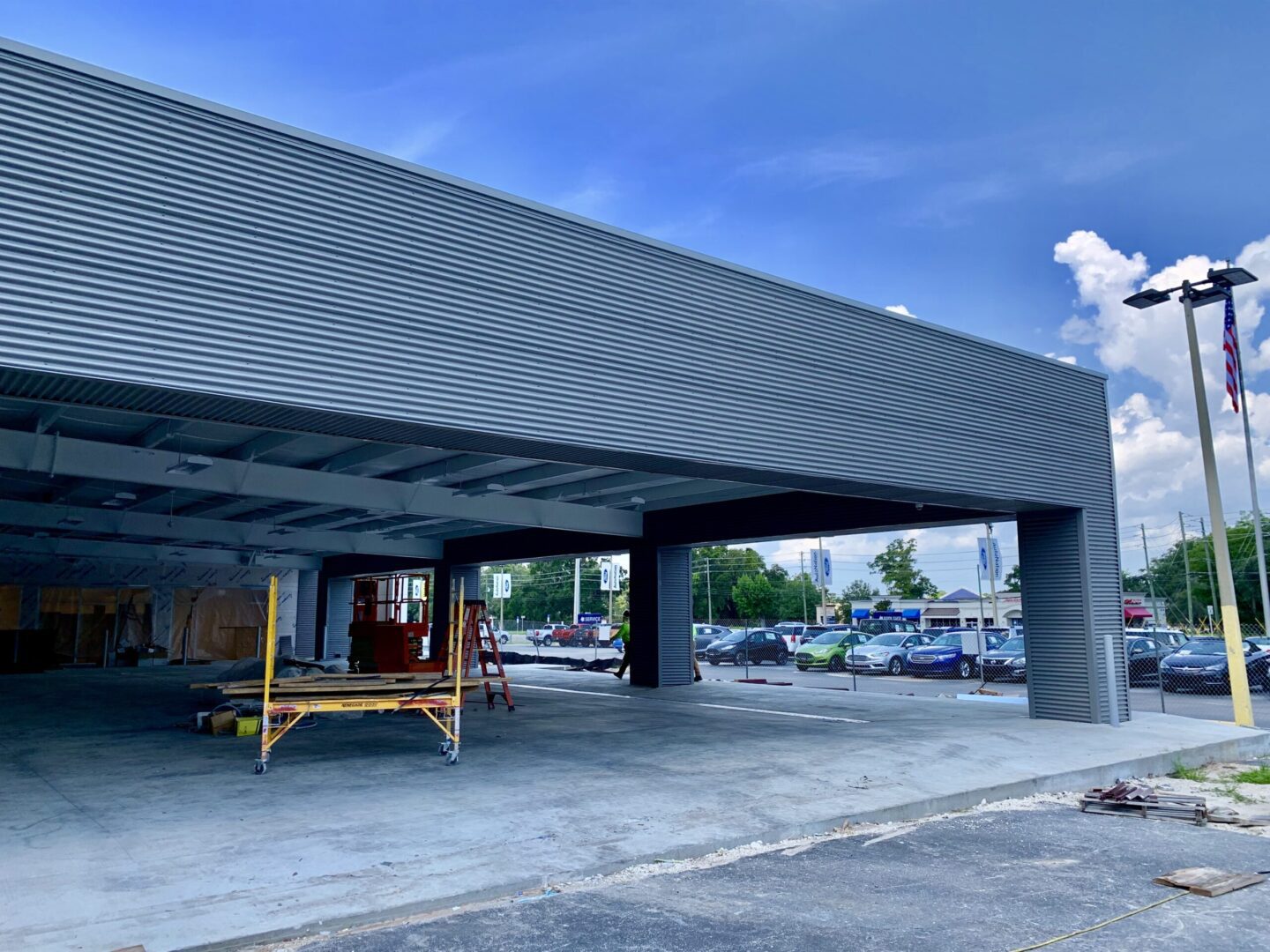 A large open parking garage under a blue sky.