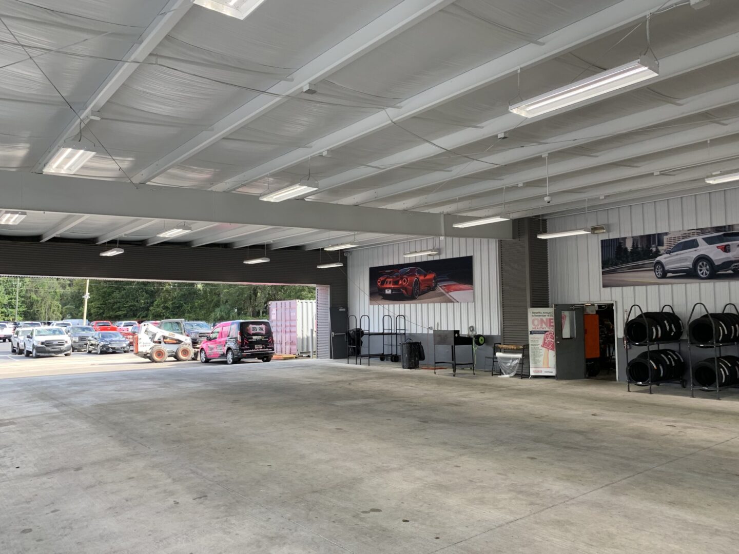 A large empty garage with lots of cars parked in it.