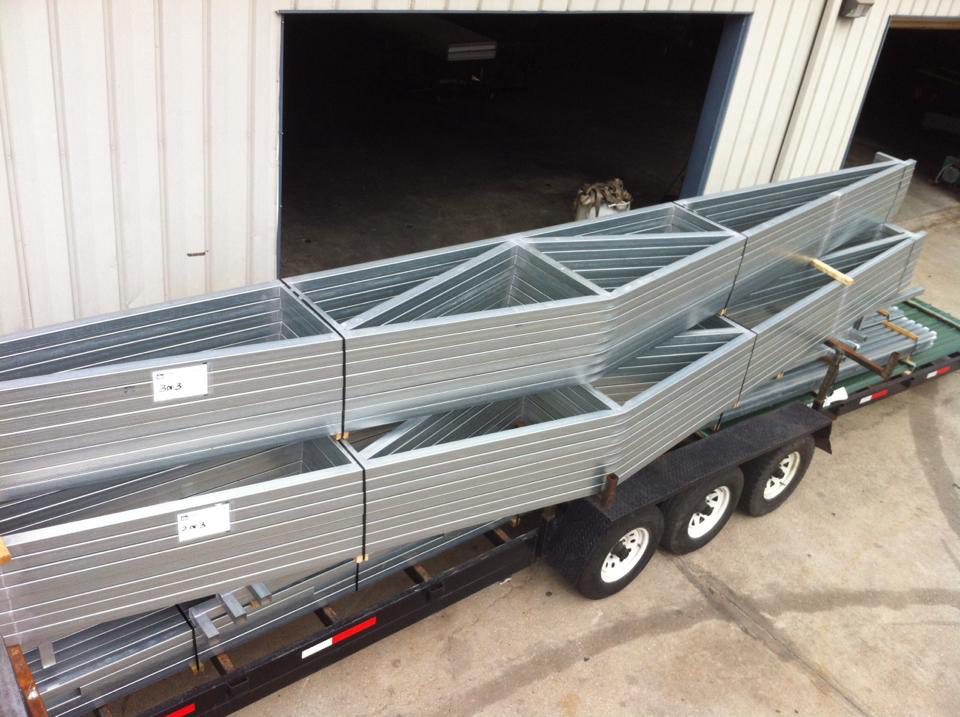 A trailer with two large metal boxes on it.