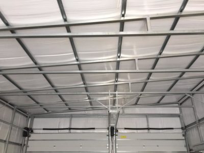 A ceiling with metal bars and white walls.