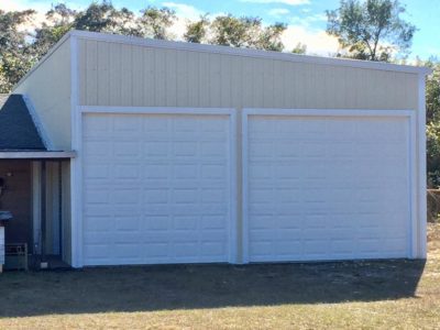A large white garage with two doors.