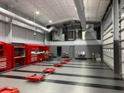A warehouse with many red carts in it