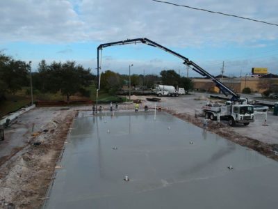 A concrete slab being poured for a building.
