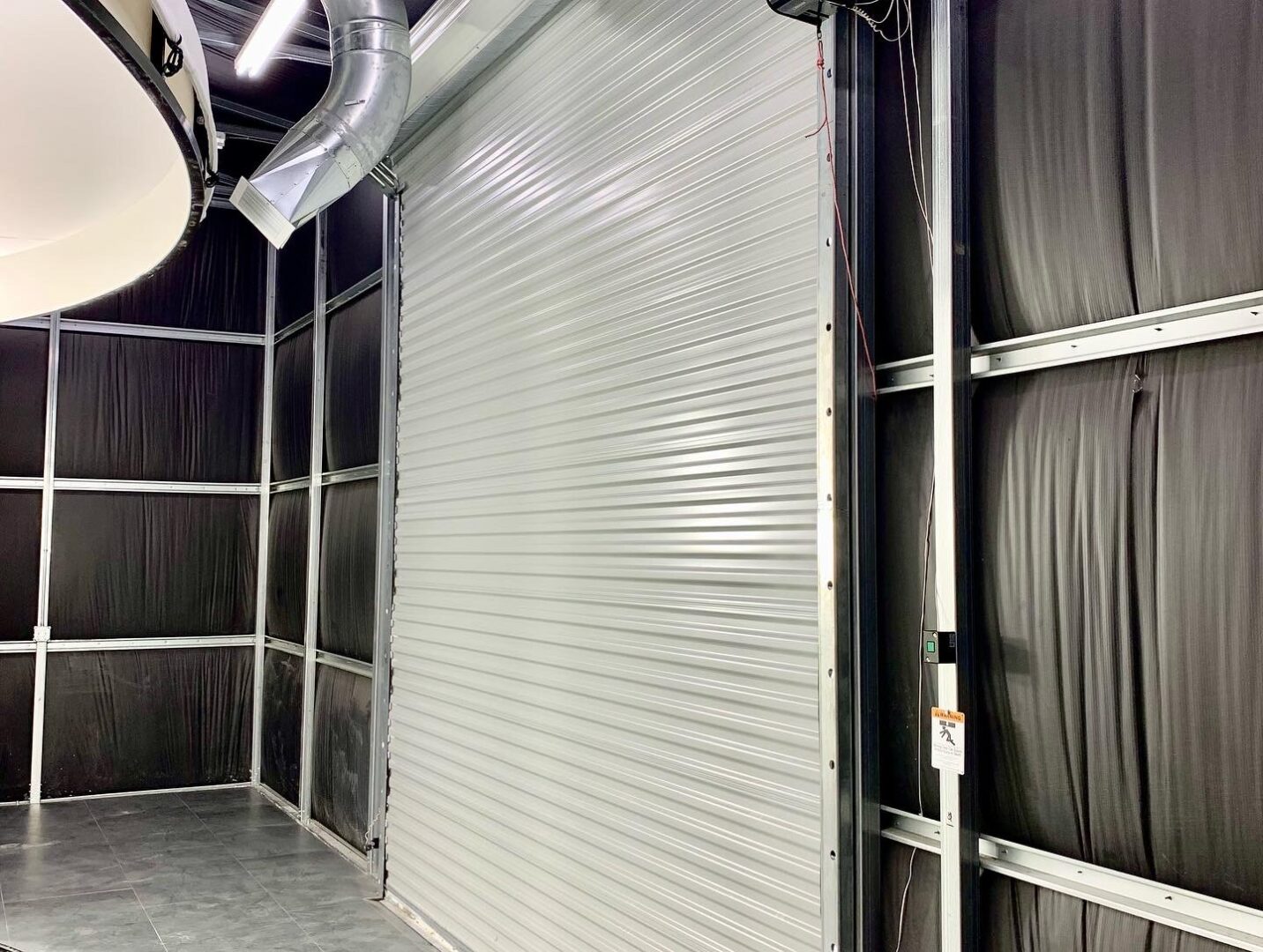 A warehouse with a large roll up door.