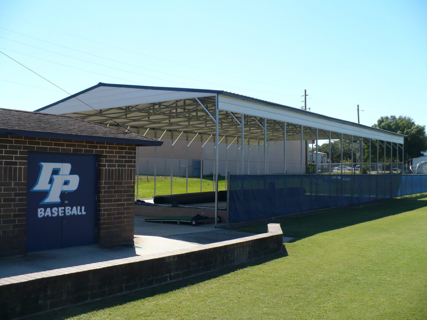 A baseball field with a dugout and bleachers.